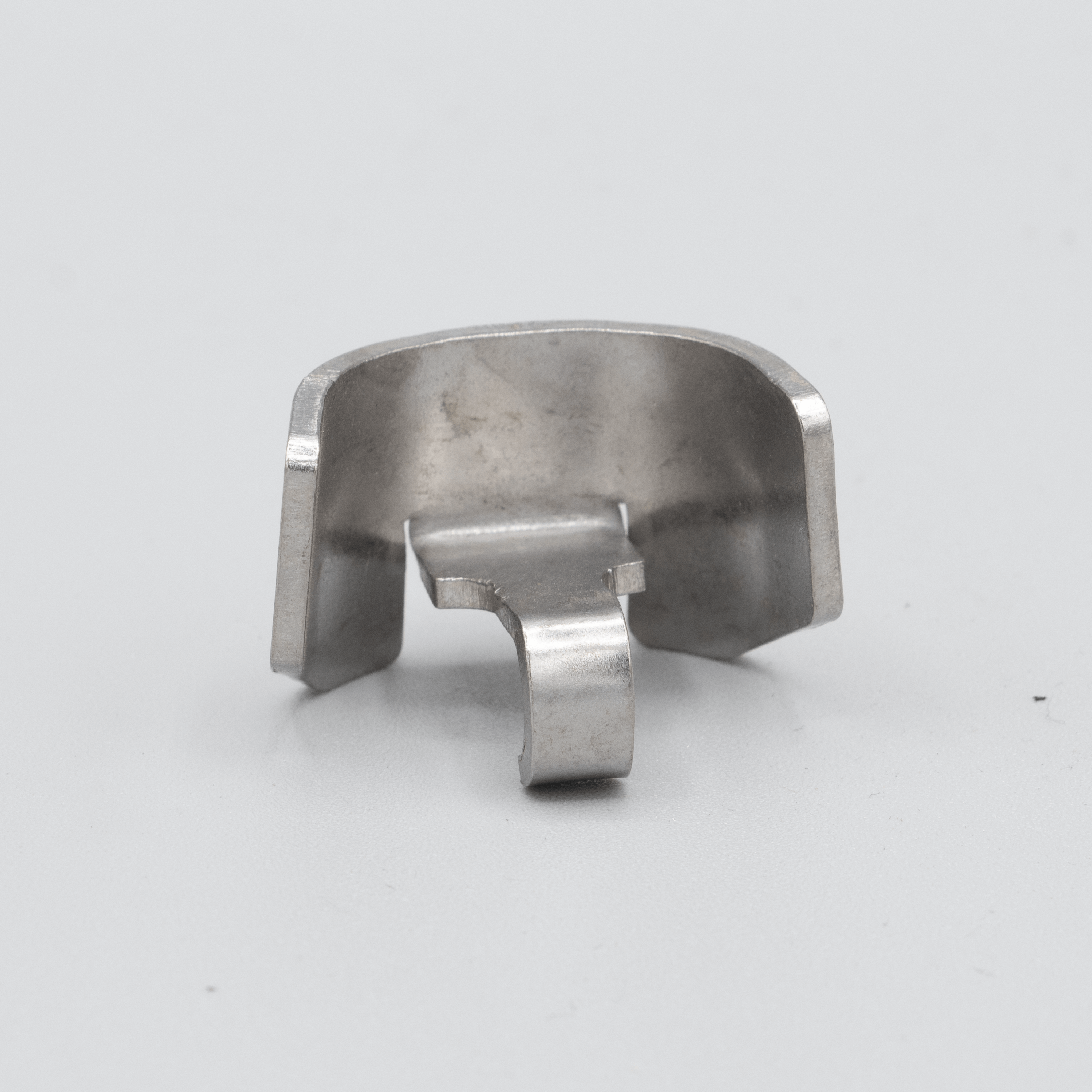 Here's an alt tag for the image: Silver metal retaining clip.
