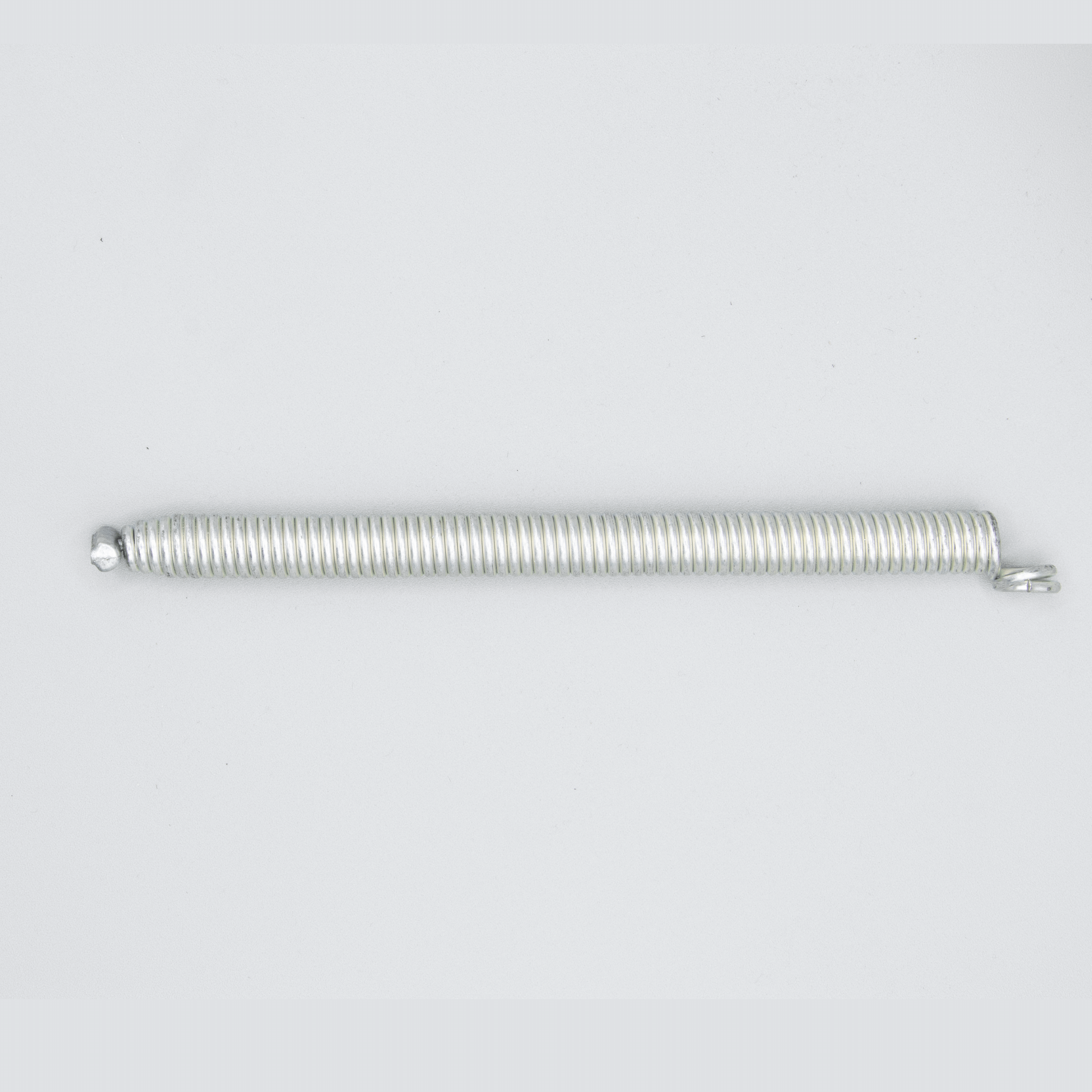 Here's an alt tag for the image: Metal coil spring isolated on white.