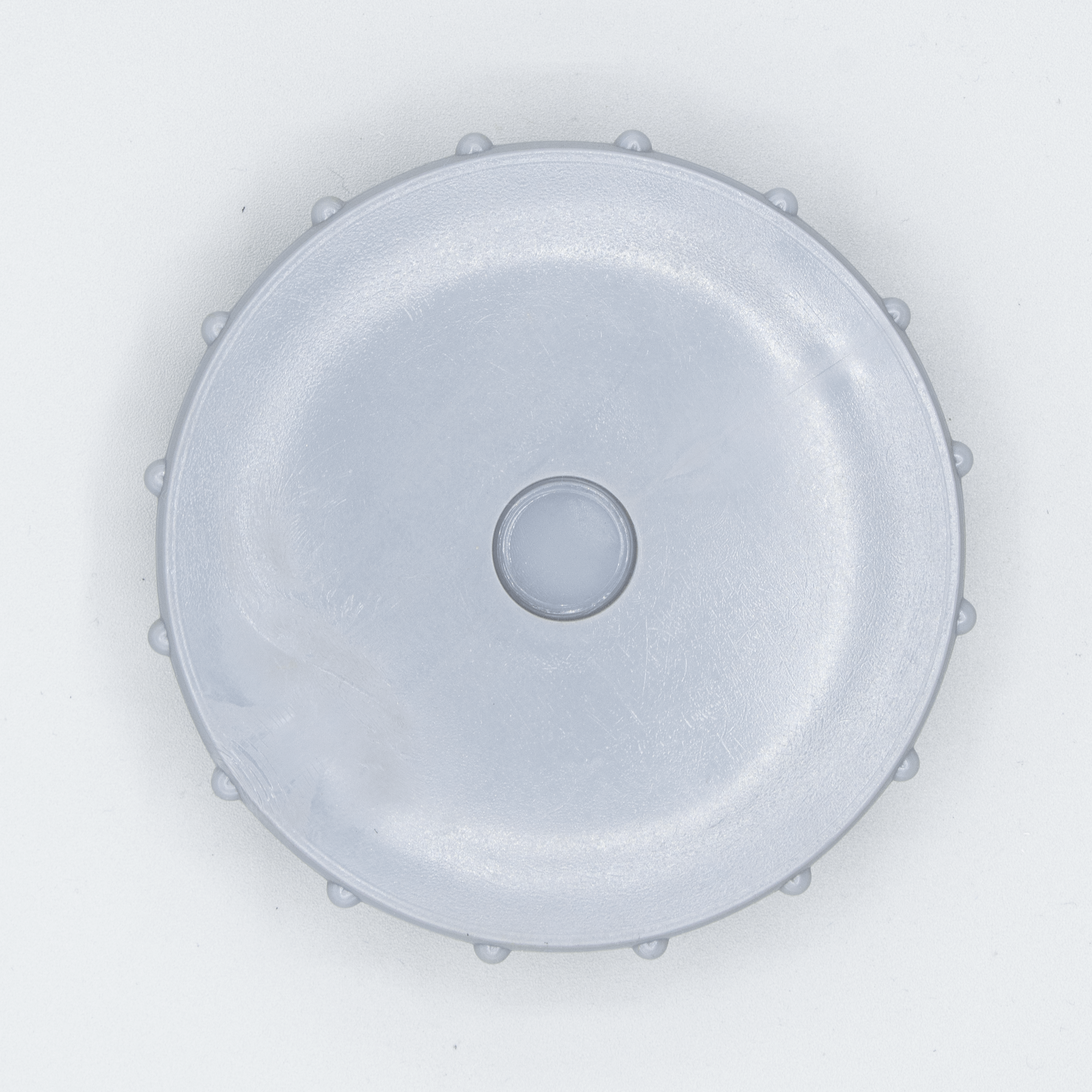 Gray plastic lid with a center hole.