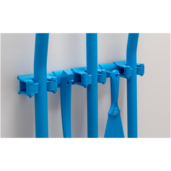 Blue cleaning tools on wall rack.