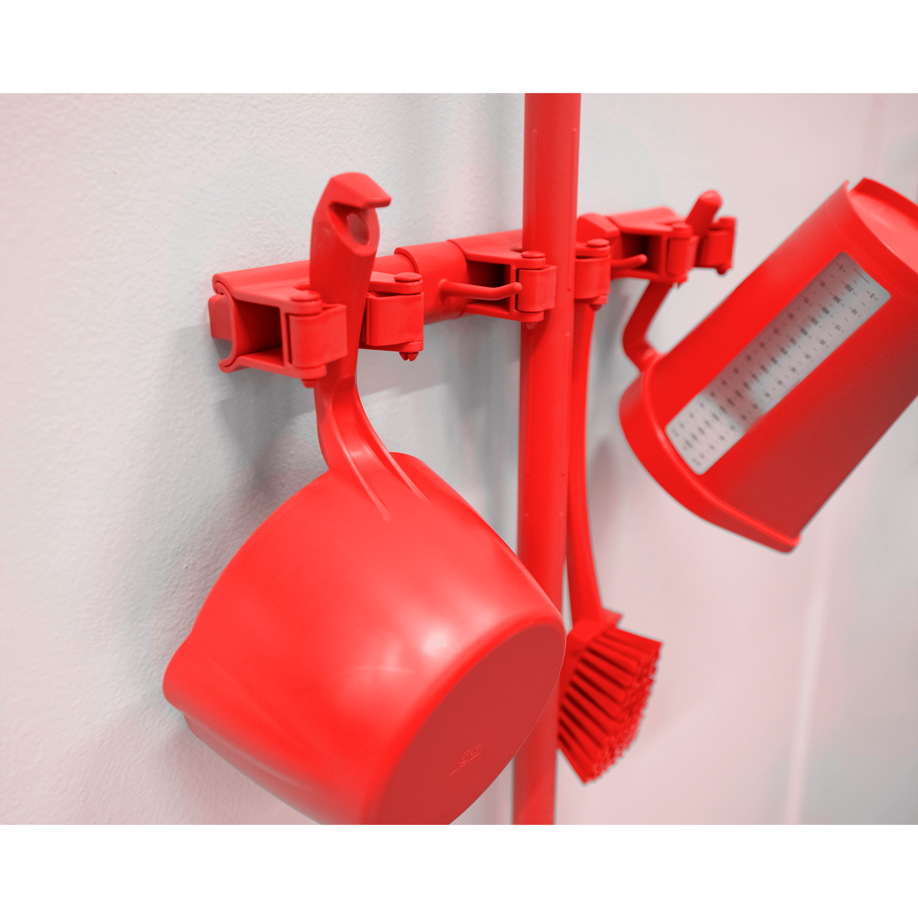 10114-2 Red measuring cups and brush on wall.