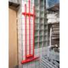 Red cleaning brushes hanging on wall.