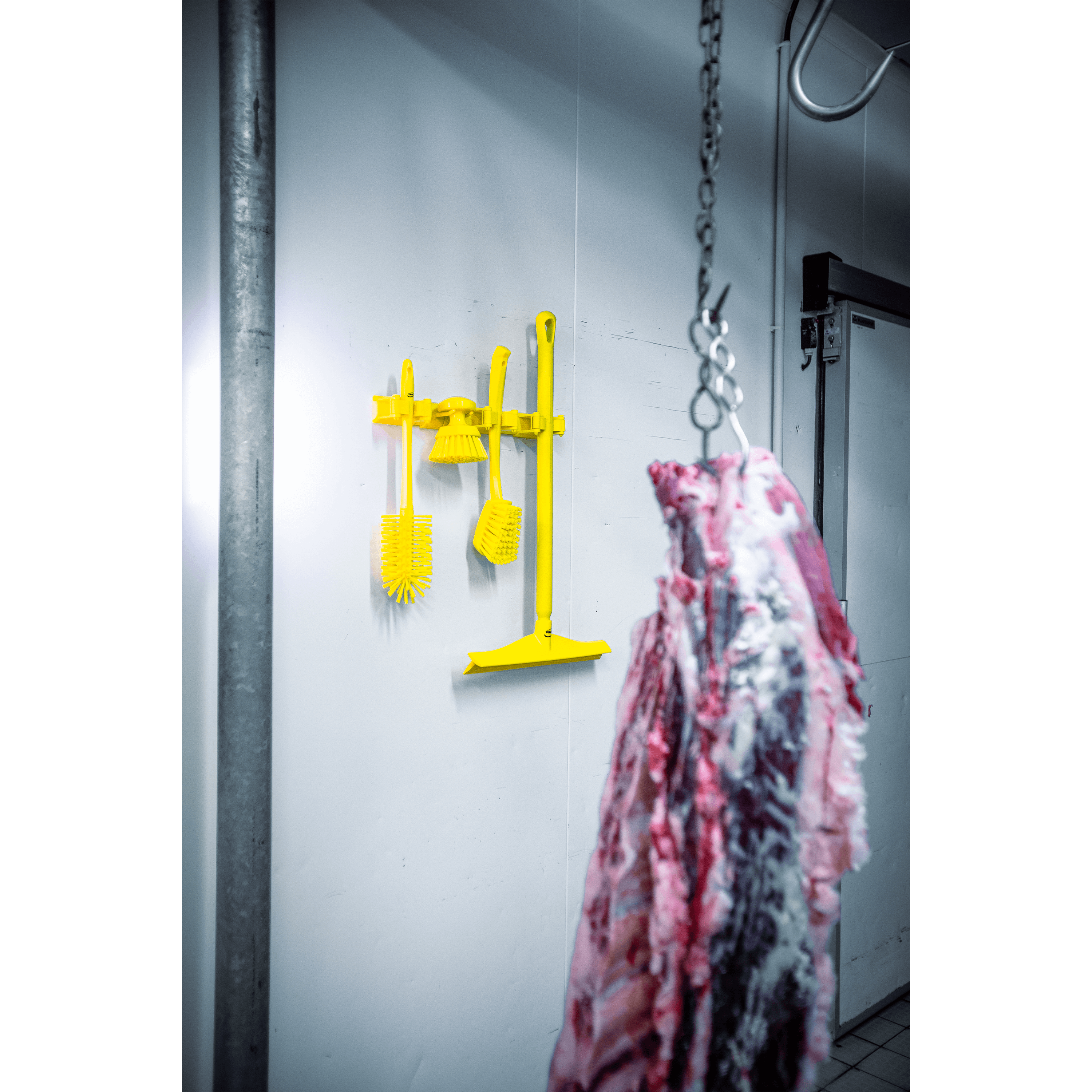 Yellow cleaning tools and a meat carcass.