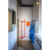 Orange cleaning supplies in a white room.