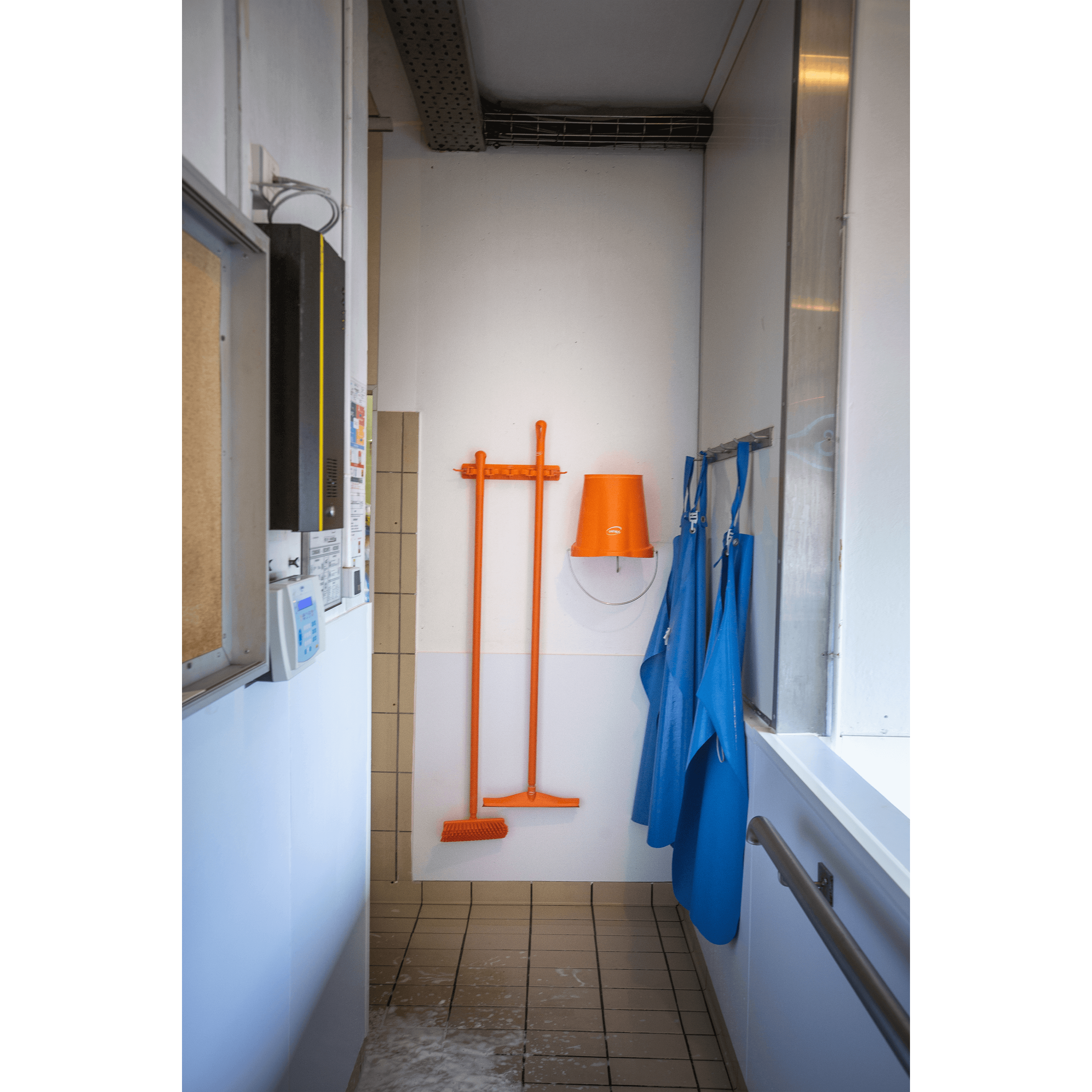 10117-4 Orange cleaning supplies in a white room.