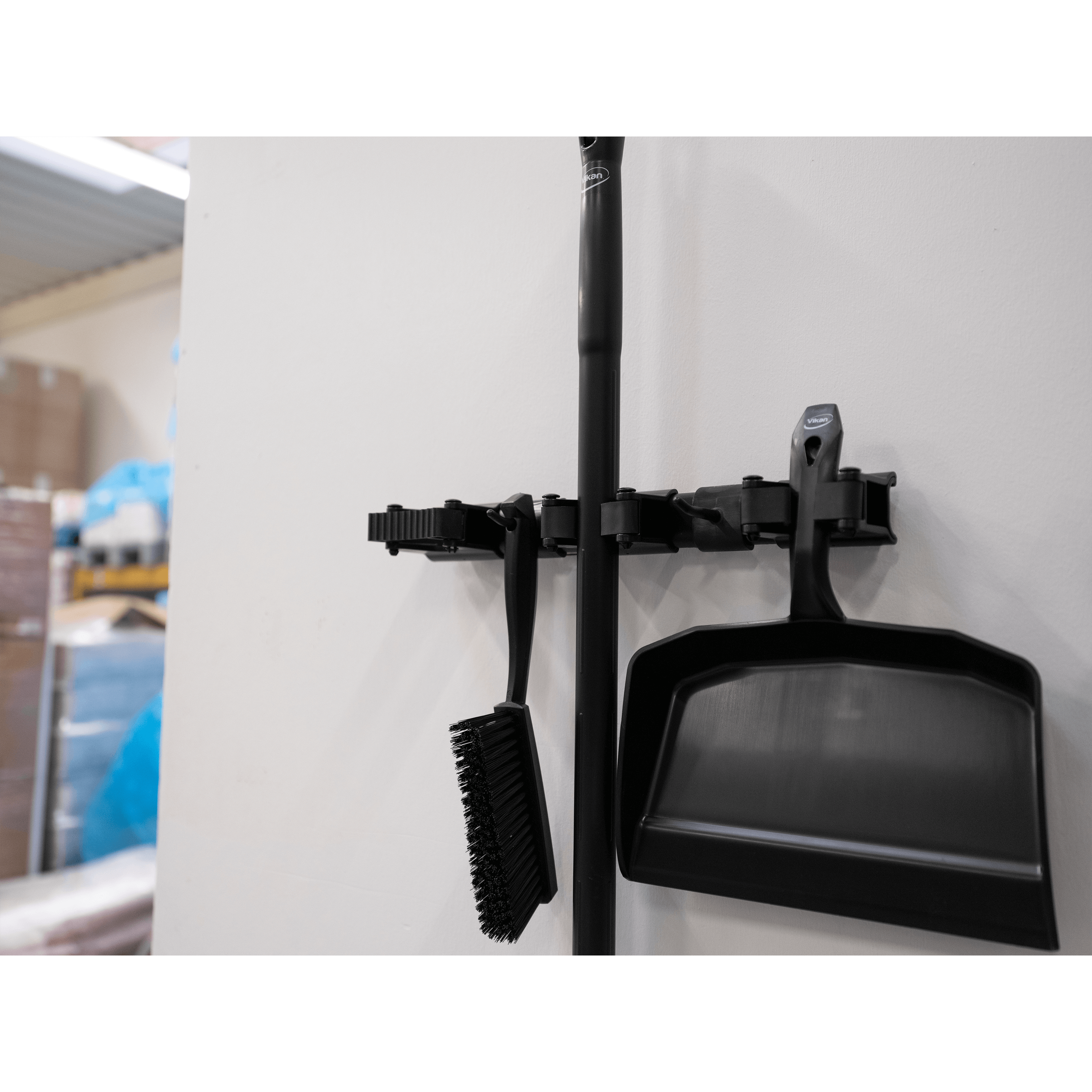 10119-2 Black broom, dustpan, and mop holder.