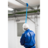 Worker using brush to clean pipe.