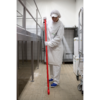 Woman in white scrubs cleans tiled floor.