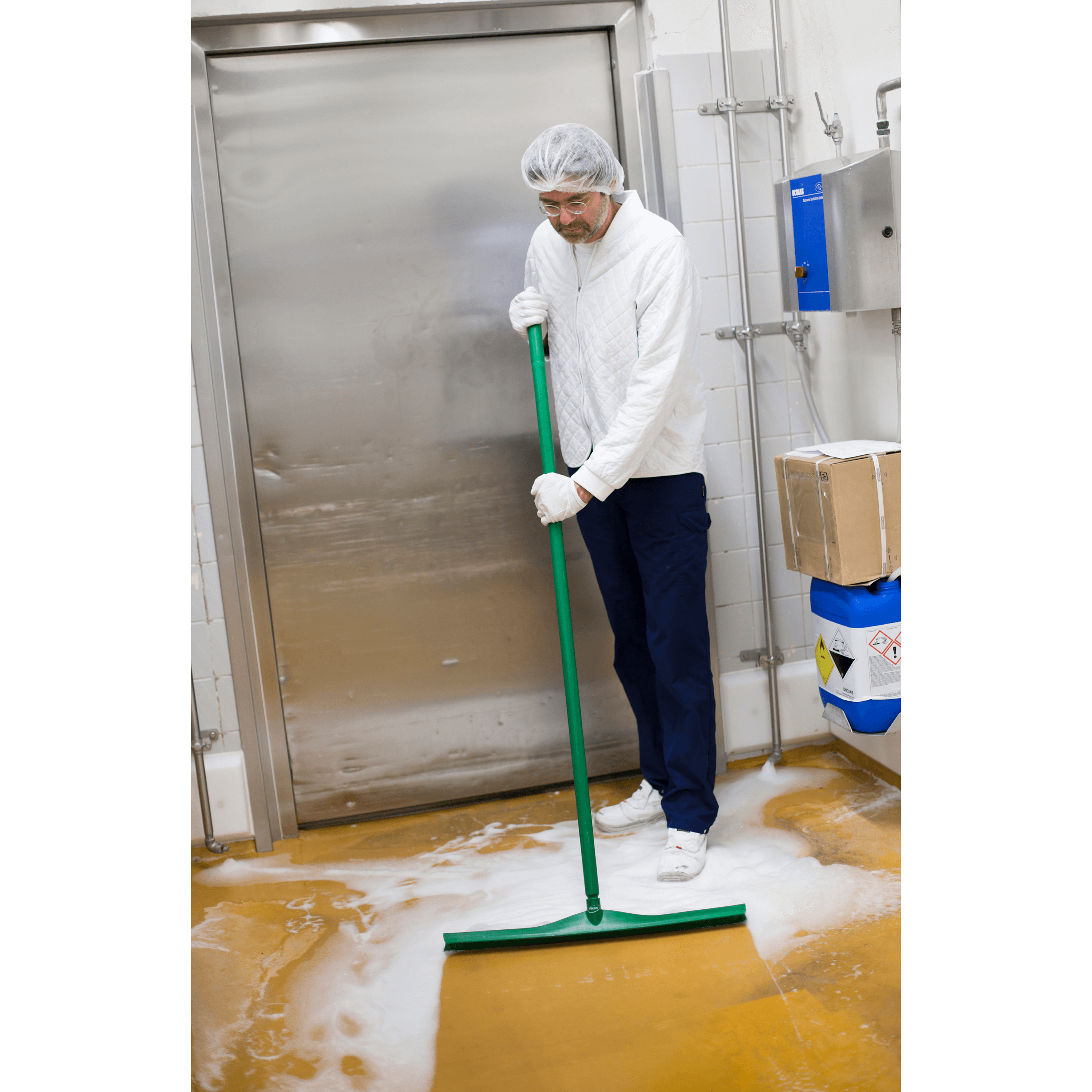 29622-3 Man in a white coat mopping a floor.