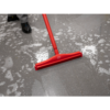 Red floor squeegee on a wet floor.