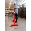 Woman sweeping floor in a bakery.