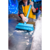 Person cleaning ice with a blue brush.