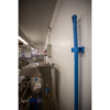 Blue mop handle mounted on white wall.