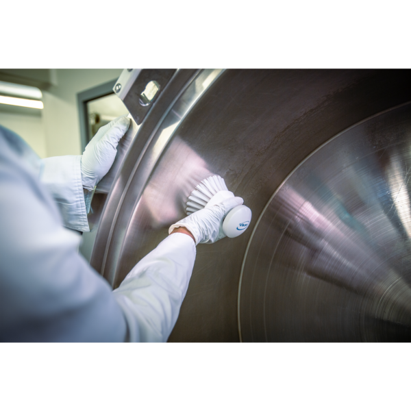 Hand in glove cleans stainless steel surface.